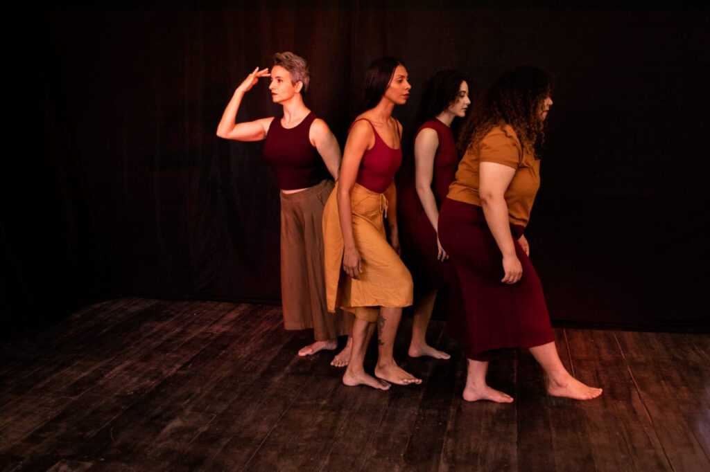 Grupo de quatro bailarinas em cena, com poses expressivas.